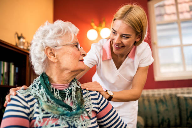 A caregiver assisting an elderly woman, symbolizing the care and emotional connection that can be enhanced by meaningful gifts for senior female relatives.