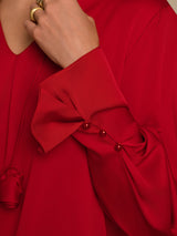 Black silk V-neck blouse with long sleeves and 3D rose detail