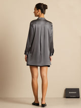 Dark silk stand-collar blouse with button front and high-low hem, worn by a model
