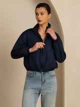 Woman wearing a reversible silk satin stand-collar jacket with pockets