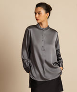 Black silk stand collar blouse with button front, long sleeves, and high-low hem