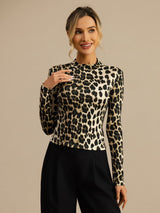 Model wearing a wild animal print silk jersey mock neck top with long sleeves