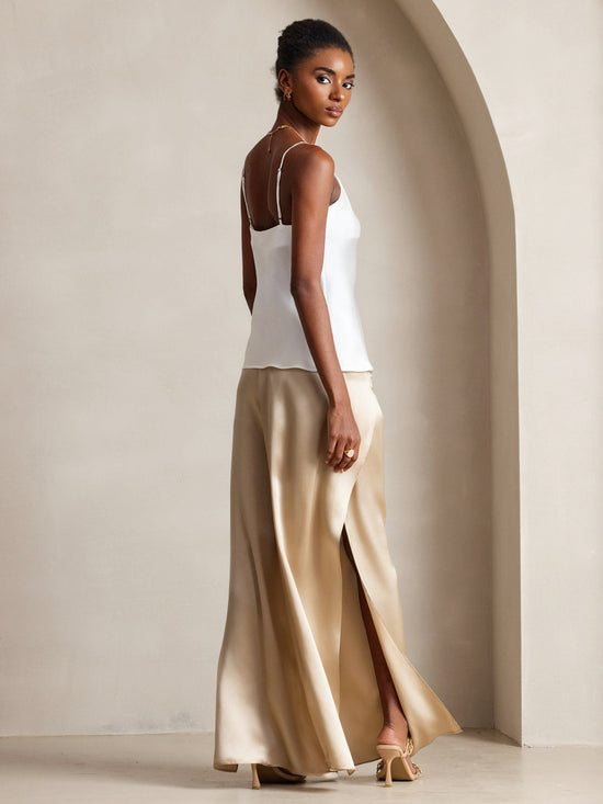 Woman in champagne cami with satin slip skirt