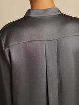 Black silk stand-collar blouse with button front and high-low hem