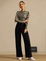 Model wears a wild animal print silk jersey mock neck top with long sleeves