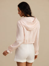 Light blue silk cropped hooded jacket with zipper, elastic waist, and side pockets