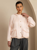 Women’s silk hooded jacket with large flap pockets, long sleeves, and relaxed fit